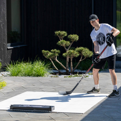 Hockey player training with passing kit outside, fueled by proper game-day nutrition